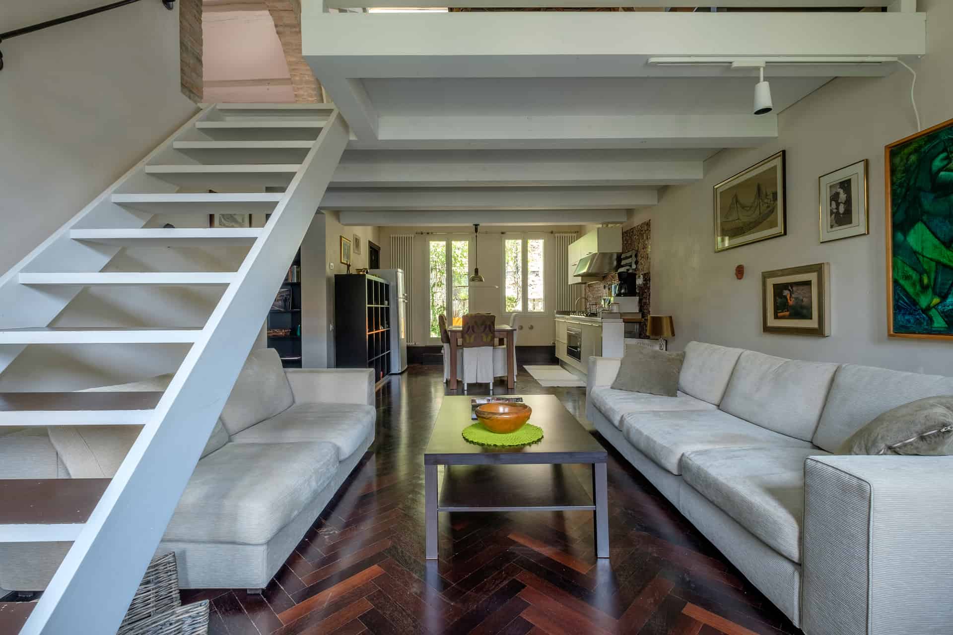 Backside of large open space livingroom with stairs - Attico Terrace Apartment