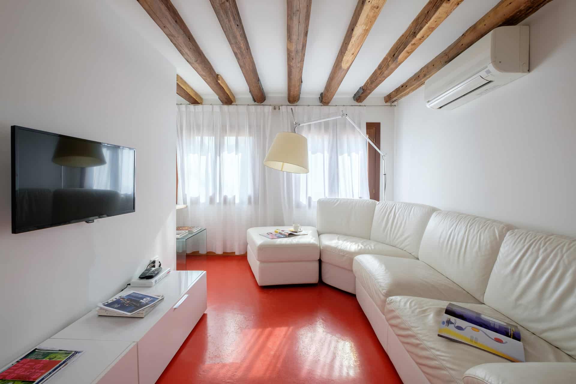 Luminous living room with large white sofa - The Lion's 4 Apartment