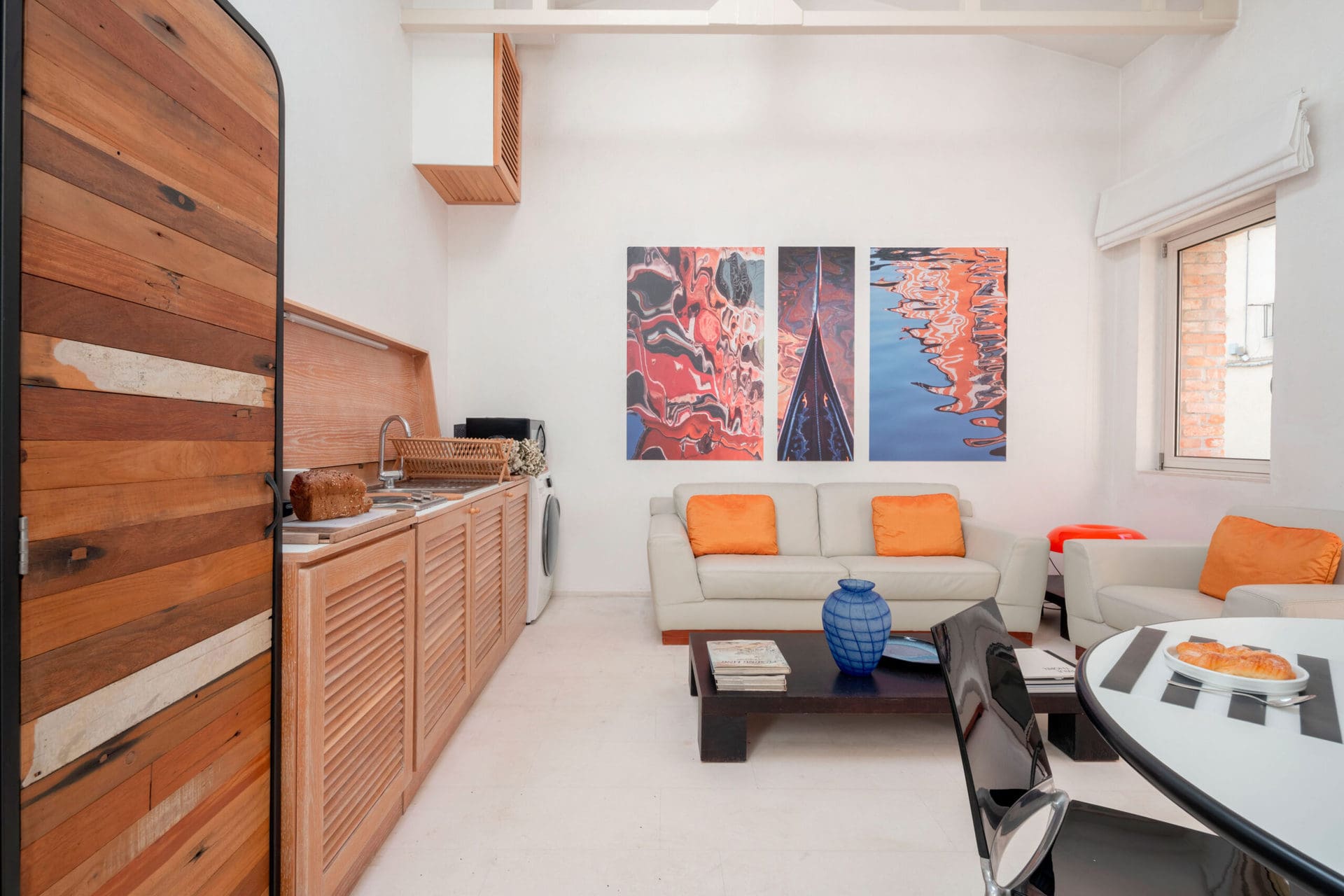 Open space living room and kitchen with modern furniture - The Waterview Alcove Apartment